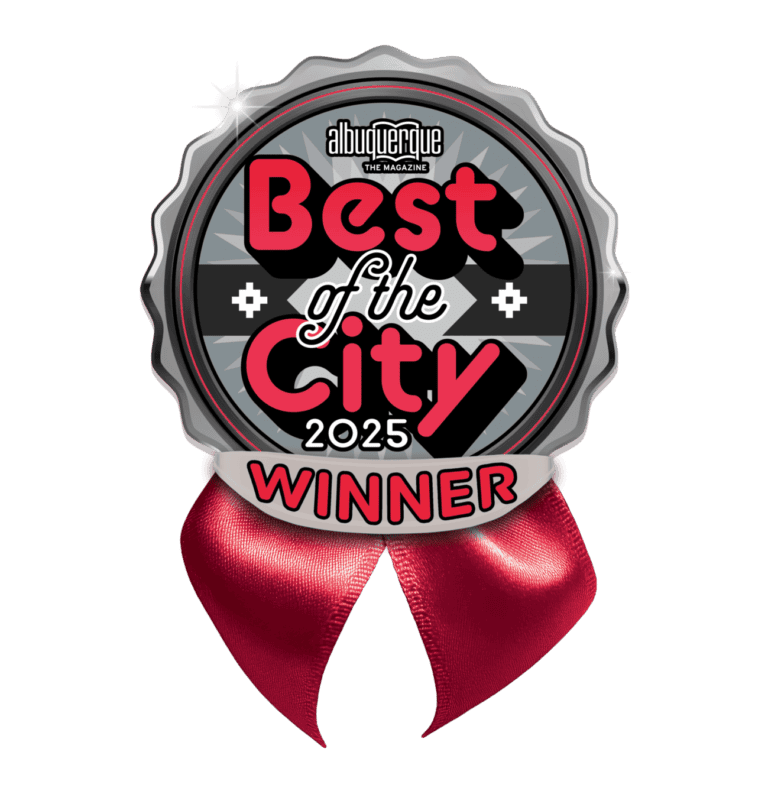 A round badge with a red ribbon reads “Albuquerque The Magazine Best of the City 2025 Winner” in bold letters, featuring decorative black, white, and red accents—an honor also celebrated among Yelp’s Top 100 Restaurants.