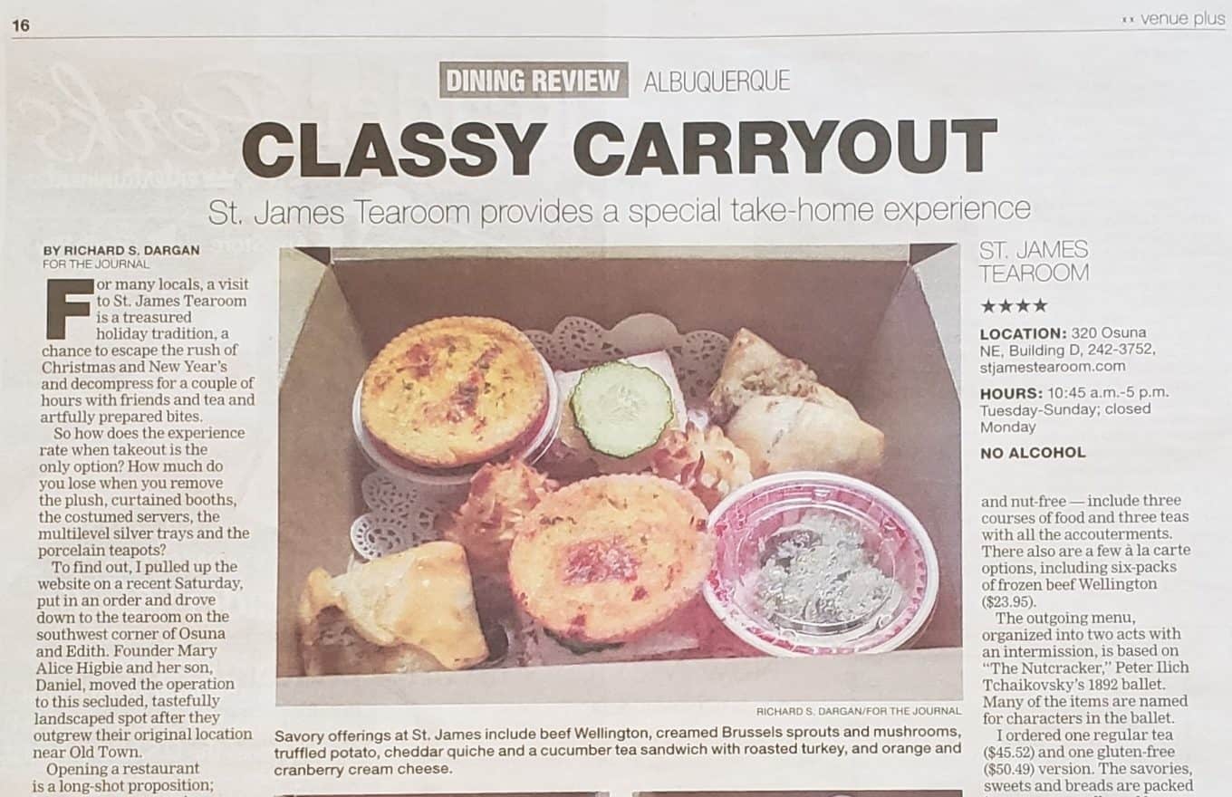 A newspaper article features a photo of a box with assorted savory pastries, a small container of sauce, and a tea bag, showcasing St. James Tearoom’s take-home meal offerings. The article headline reads “Classy Carryout.”.