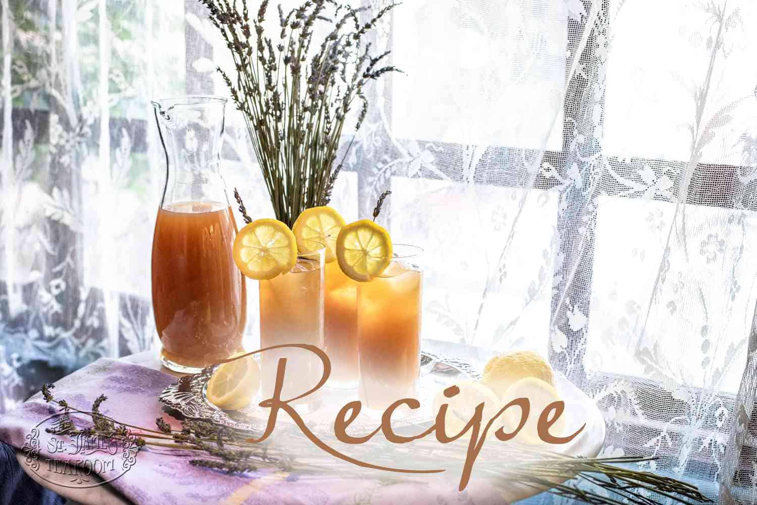 A pitcher and two glasses of iced tea with lemon slices and lavender sprigs on a table by a bright window evoke the refreshing flavors of a Lavender Lemonade Recipe, with the word “Recipe” written across the image.