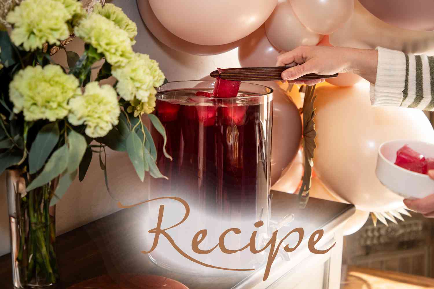 A hand serves red punch with ice from a glass container, reminiscent of a Peach Iced Tea Recipe. Pink balloons and green flowers are nearby. The word “Recipe” is written at the bottom.